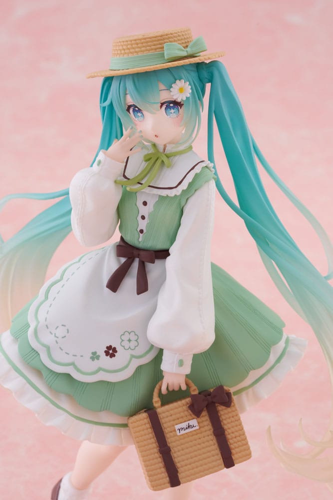 Figurine Hatsune Miku Fashion Country Ver. de 18 cm, en robe verte avec tablier blanc, chapeau de paille, panier tressé et longues couettes bleu clair dégradées.