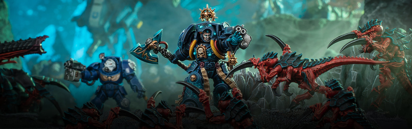 Figurines Space Marines affrontant des Tyranides dans une scène de bataille Warhammer 40K – mise en avant des unités d’élite de l’Imperium dans l’univers de Warhammer 40,000.