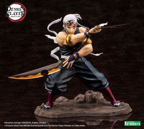 Figurine de Tengen Uzui de Demon Slayer en pose de combat, tenant deux sabres, sur un socle rocheux. Il porte son bandeau orné de pierres précieuses et sa tenue de shinobi sans manches, mettant en valeur sa musculature.